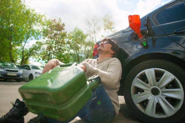 istock Upset man with empty refuel canister  near his car 1421915183