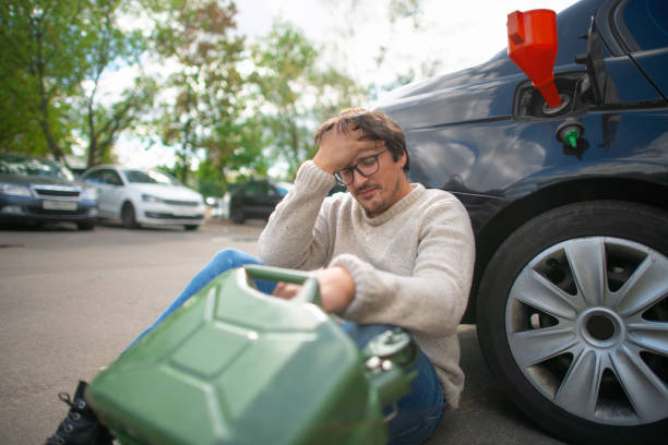 istock Upset man with empty refuel canister  near his car 1421915217