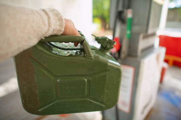 istock Man with refuel canister  at a gas station 1421916182