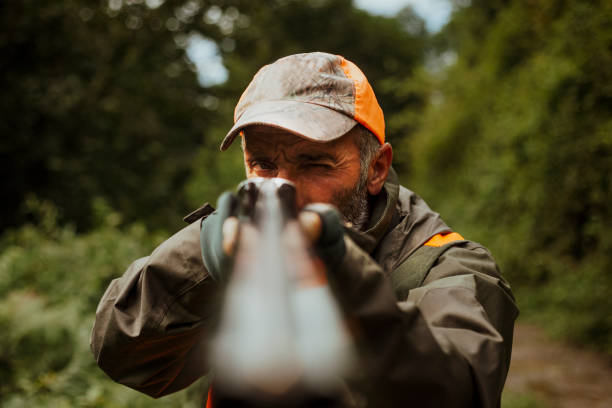 istock photo of hunter aiming with rifle 1421919332