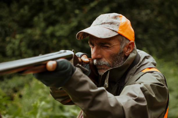 istock photo of hunter aiming with rifle 1421919333