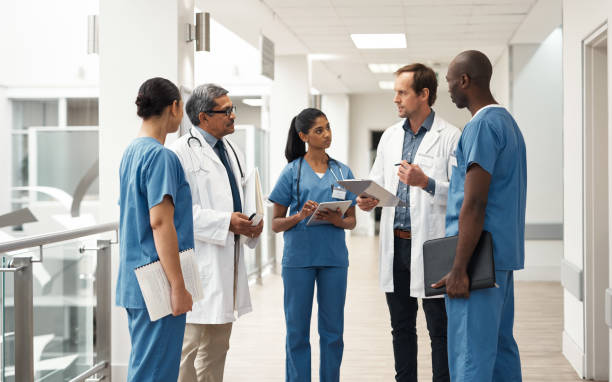 Doctor, nurse and medical meeting with tablet, paper and lab data for medicine innovation idea and research in hospital. Teamwork, healthcare leadership and collaboration communication in help clinic stock photo