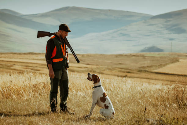 istock young hunter and her dog in modern hunting clothes 1421919855