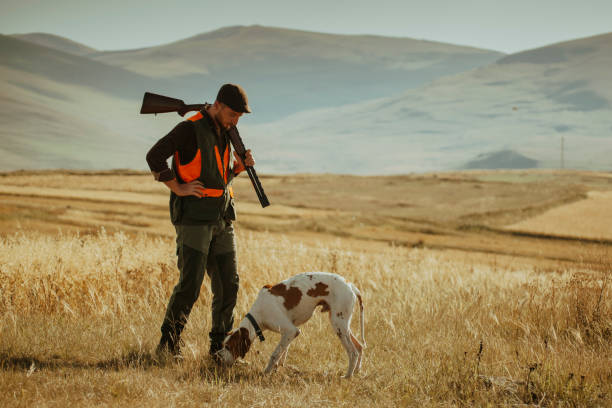 istock young hunter and her dog in modern hunting clothes 1421919898
