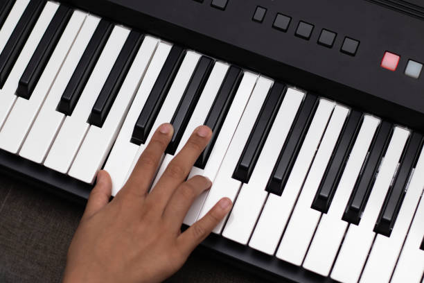 istock Nimble fingers Of Kid Playing Notes On Piano Or Keyboard. Musical Training Or Coaching, Learning, Home Activity, Amusement, Live Music Concert, Entertainment, Leisure And Hobby, Summer Camp Concept 1421920492