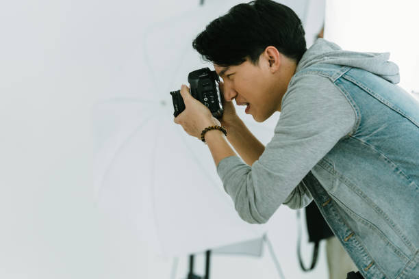 istock Asian Photographer shooting with model in Studio 1421923419