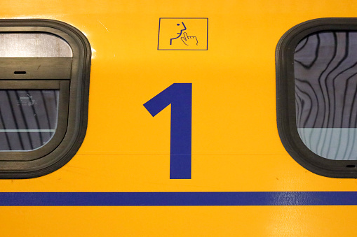 Number 1 for silent first class Refurbished VIRM intercity train along platform Rotterdam Central station in the Netherlands