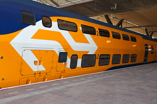 Refurbished VIRM intercity train along platform Rotterdam Central station in the Netherlands