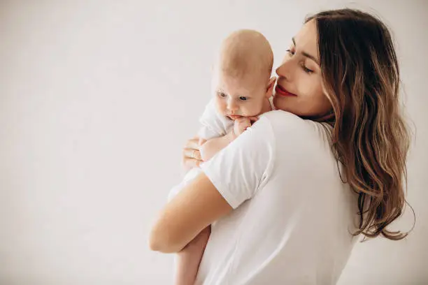 Photo of Family mother and little baby, beautiful and happy together, portrait on white background