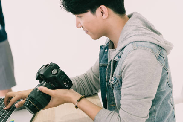 istock Photographer checking picture in camera 1421926824
