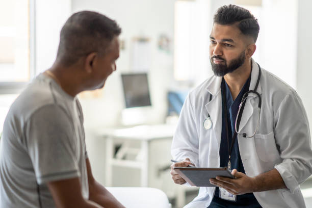 istock Male Doctor Talking with a Patient 1421926850