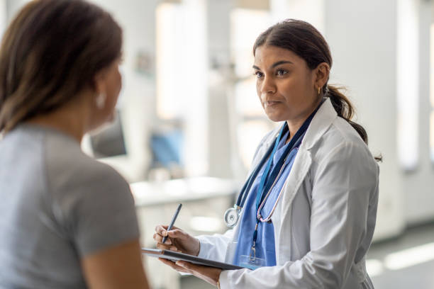 istock Female Doctor Talking with a Patient 1421926851