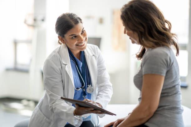 istock Female Doctor Talking with a Patient 1421926855