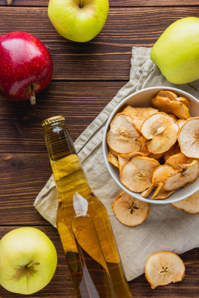 istock Apple cider in a bottle on a wooden table 1421927130