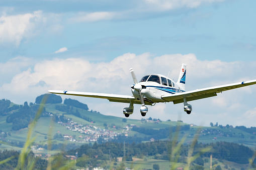 Wangen-Lachen, Switzerland, July 31, 2022 Piper PA28-181 Archer II is landing on a small airfield