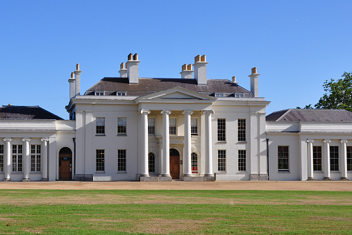 Public Hylands Park, Chelmsford, Essex, United Kingdom, September 7, 2022. Stately home or neo classical Queen Anne Palladian mansion. Front elevation. Outdoors on a sunny summer autumn day.