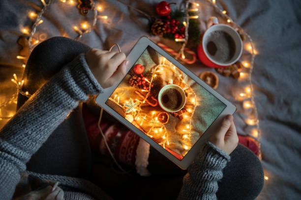 istock A woman sitting on a bed holding a digital screen 1421931333