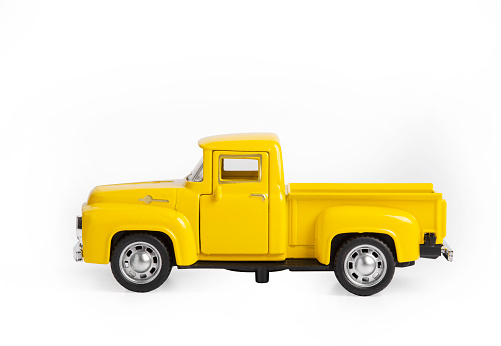 yellow toy car the truck isolated on a white background.