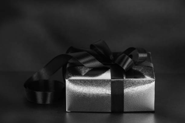 istock Black gift box on black background for Black Friday concept 1421935248