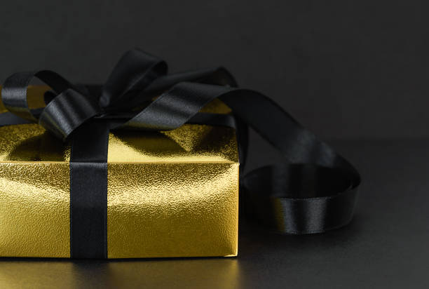 istock Christmas gift with black ribbon close-up 1421935250