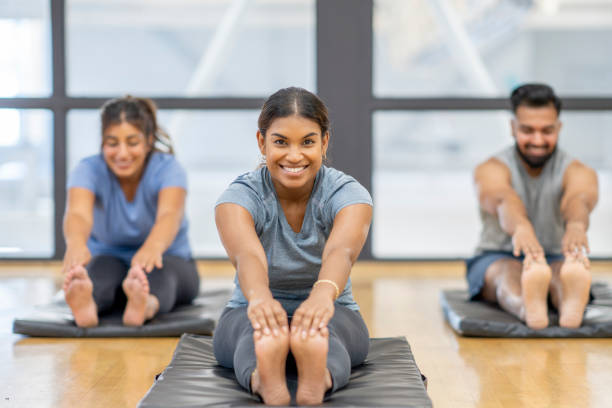 istock Adults Stretching in a Fitness Class 1421937523