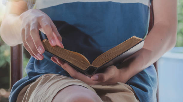istock Young man opening and reading while holding pocket book for education. 1421937694