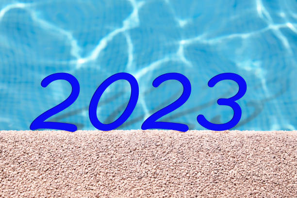 istock Number 2023 on a blue water pool. New year 1421938072