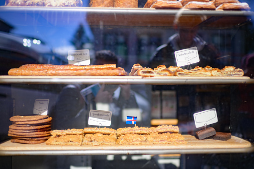 Sweet biscuits and cakes in the window of a Icelandic Bakery with Iceland flags Reykjavik, Iceland