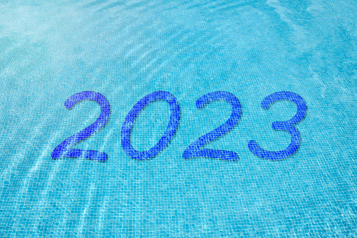 Number 2023 under blue water at the bottom of a pool. New year concept. invitation