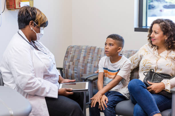 istock Mother and son talk to the doctor 1421938982