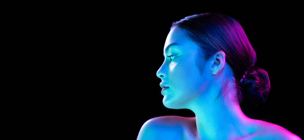 istock Flyer with young fashion model without makeup looking at camera isolated over dark background in neon light. Concept of beauty, art 1421939199