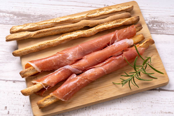 Grissini wrapped in prosciutto Grissini wrapped in prosciutto breadstick stock pictures, royalty-free photos & images