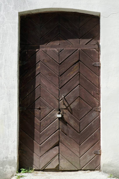 istock Locked doors to the barn at the mill. Retro. Old building 1421945724