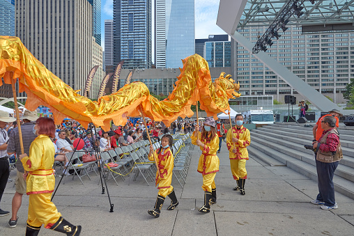Toronto Ontario, Canada- September 2nd, 2022: People doing the traditional Chinese dragon dance at Toronto's annual Dragon Festival.