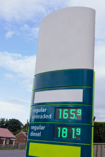 Fuel Inflation Prices Sign at a petrol station in the North East of England showing the prices of regular unleaded petrol and regular diesel fuel. Image taken during a cost of living crisis. uk petrol station price sign stock pictures, royalty-free photos & images