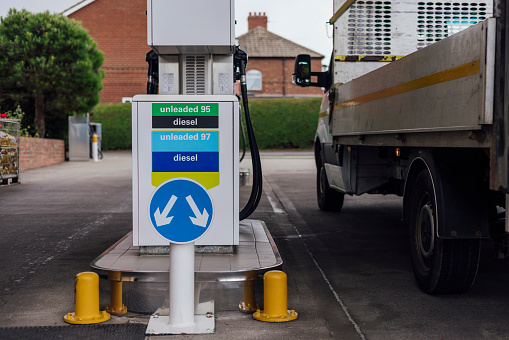 Pumps at a petrol station in the North East of England. Image taken during a cost of living crisis. A flat bed truck is parked at one of the pumps.