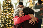istock Senior woman hugging her daughter on christmas at home 1421959902
