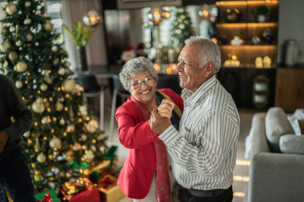 istock Senior couple dancing on christmas at home 1421960334