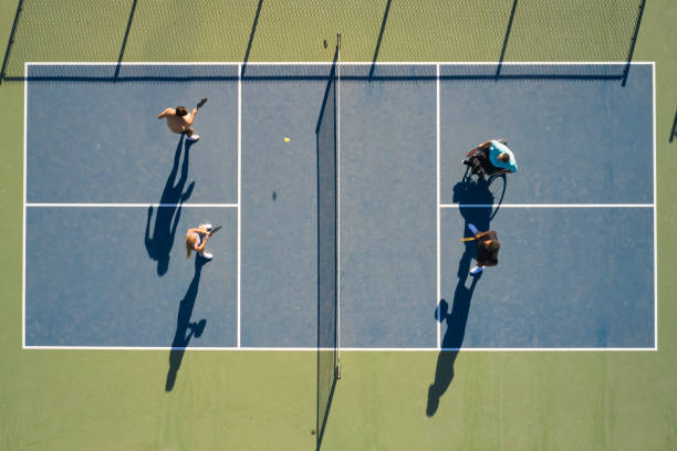 młodzi dorośli grający w pickleball na publicznym boisku - doubles zdjęcia i obrazy z banku zdjęć