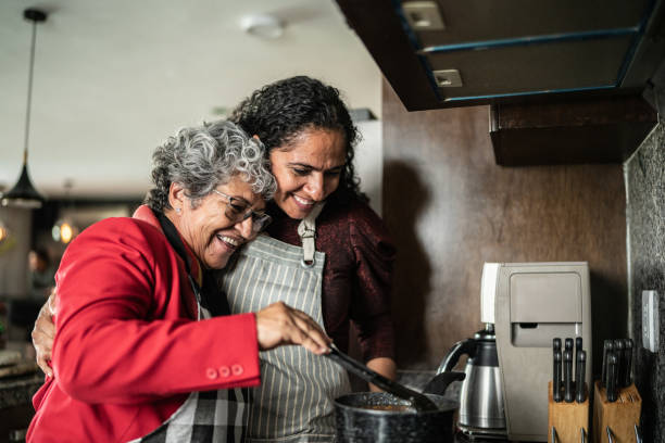 istock Mother and daughter embracing while cooking in the kitchen at home 1421965626