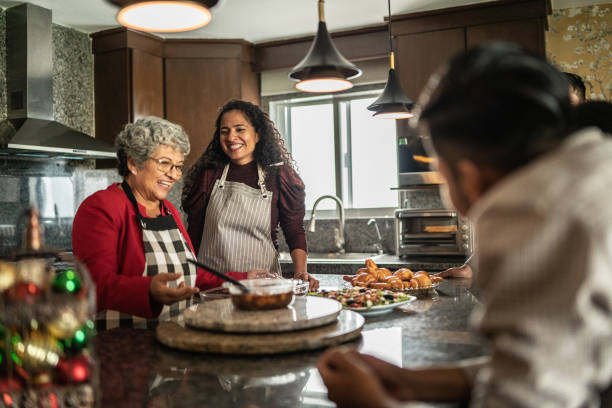 Mother and daughter preparing food for family at kitchen at home Mother and daughter preparing food for family in kitchen at home typical average stock pictures, royalty-free photos & images