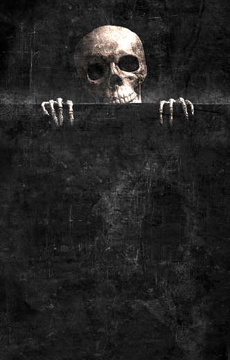 Skeleton gripping the edge of a black grunge background.