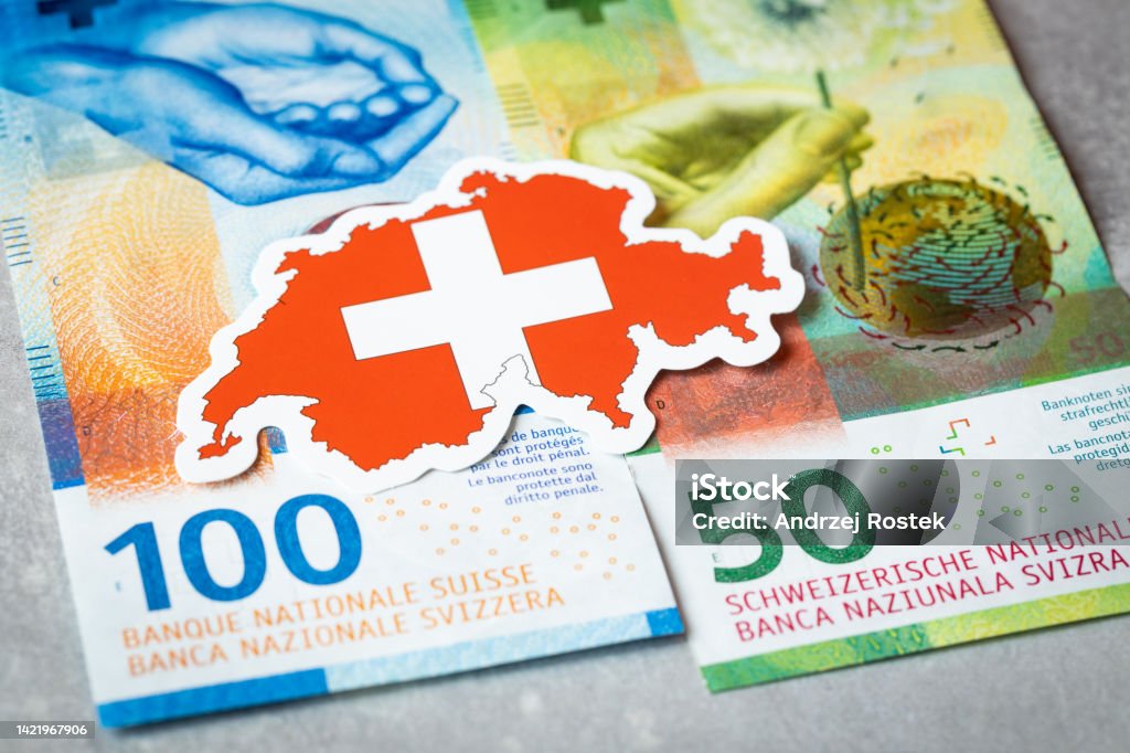 Swiss flag against the background of Swiss francs, currency security concept Swiss Currency Stock Photo
