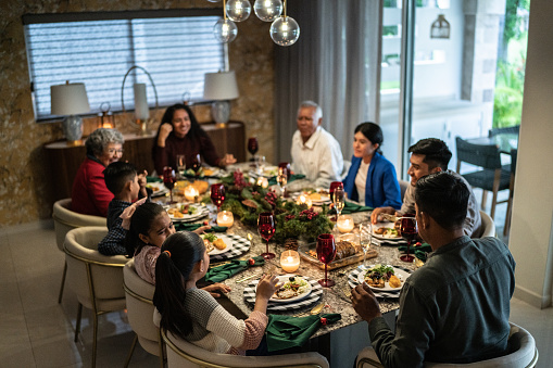 Family talking in the dinner table on christmas at home