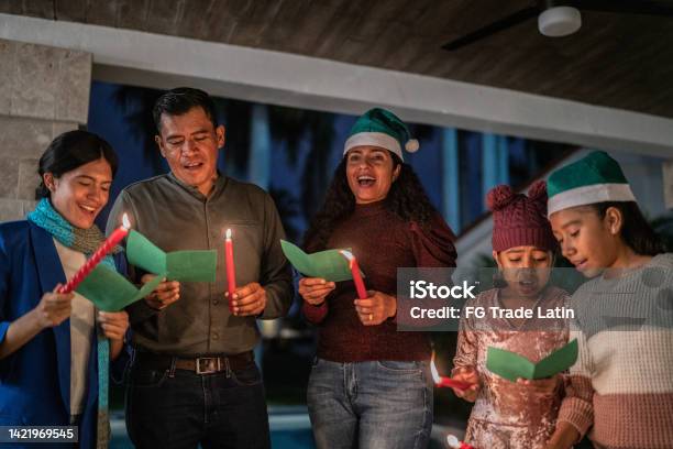 Family Singing Christmas Carols Stock Photo - Download Image Now - Christmas, Family, Singing