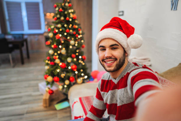 istock Young man taking a selfie at Christmas night 1421981686