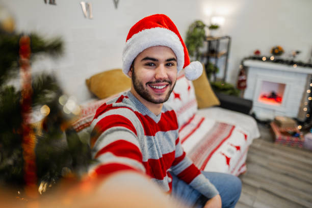 istock Young man taking a selfie at Christmas night 1421981706