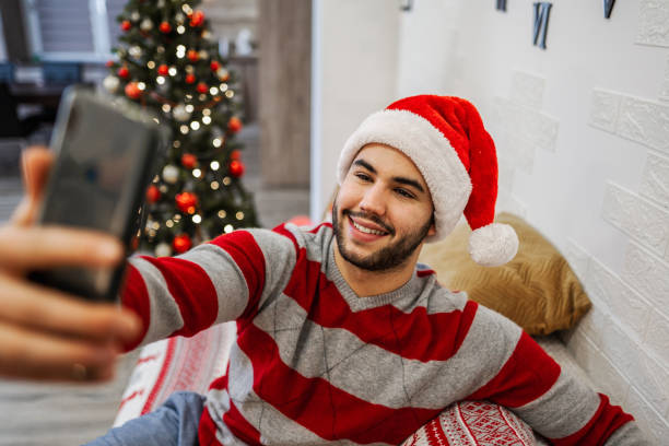 istock Young man taking a selfie at Christmas night 1421981707