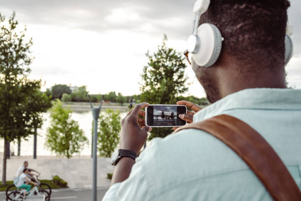 istock Young African-American man taking a picture 1421982011