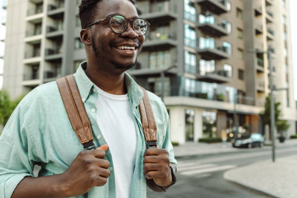istock Young African-American man walking on the street 1421982910